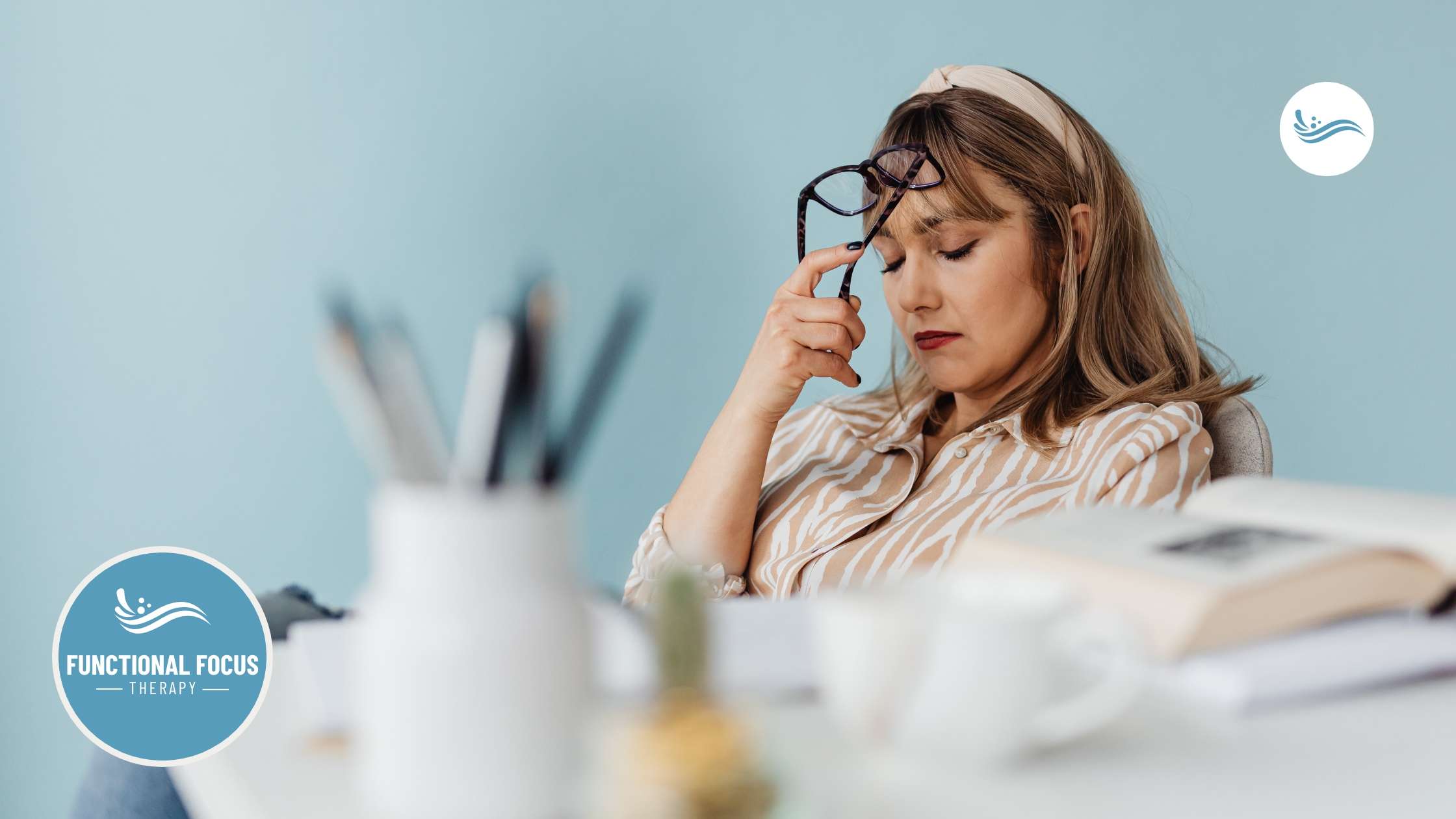 A woman thinking at her desk