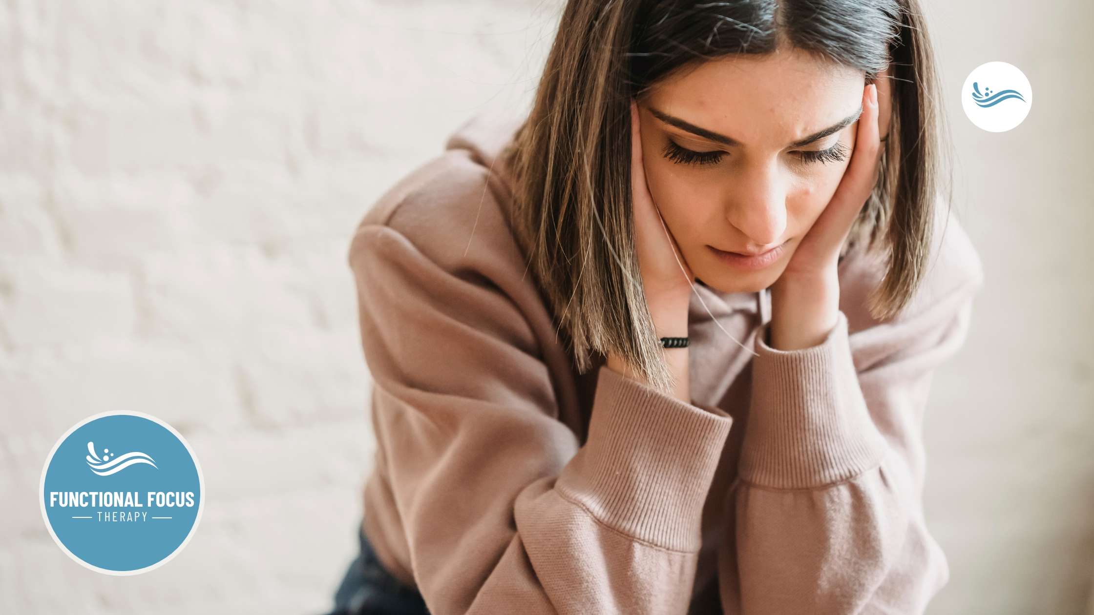 A woman holding her face, looking overwhelmed